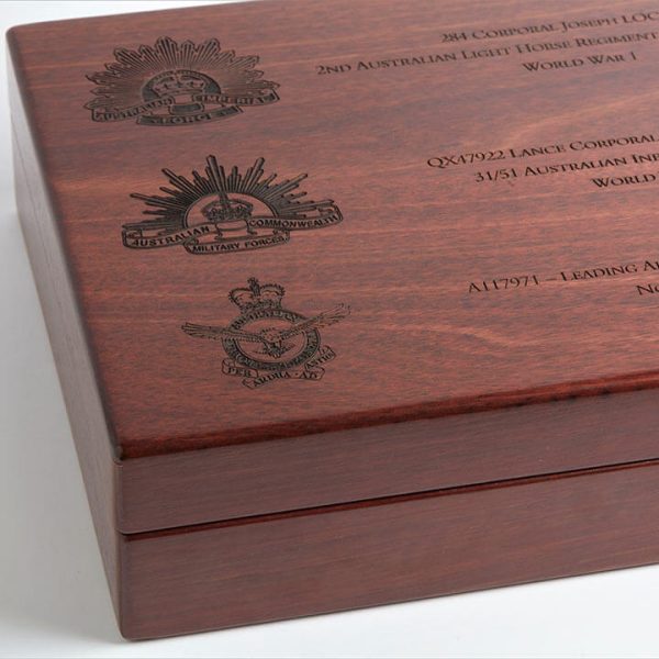 Close up of wooden lid on a4 presentation medal box, showing personalised engraving.