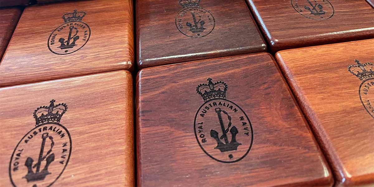 Engraved wooden boxes with emblem on lid, created out of beautiful jarrah redwood.