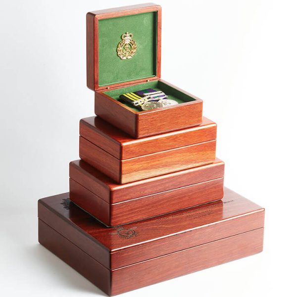 Stacked pile of varying sized medal boxes by Murphy's of Healesville, with small medal box on top open to show medals.
