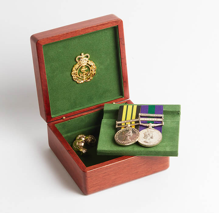 Small medal box, open to show medals, with green lining in the base.