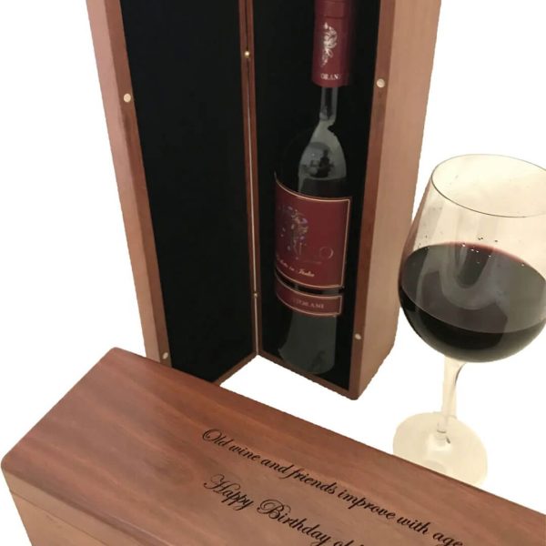 Engraved wooden wine box used for corporate gifts, with red wine inside.