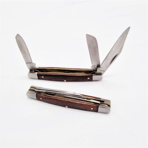 Wooden pocket knife, opened to show different blade sizes.
