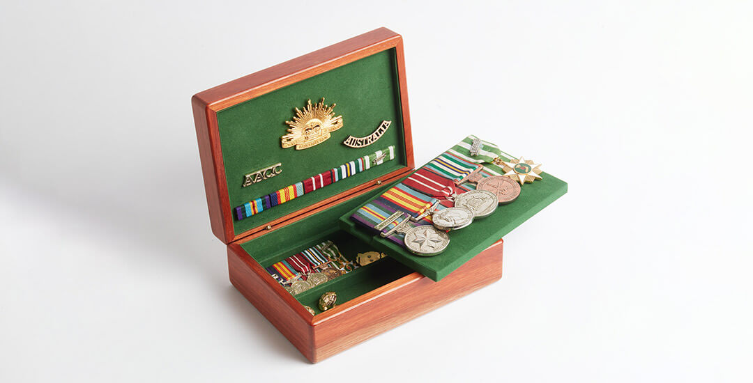 One of Murphy's medal boxes made from jarrah wood, opened to show military medals on green velvet.